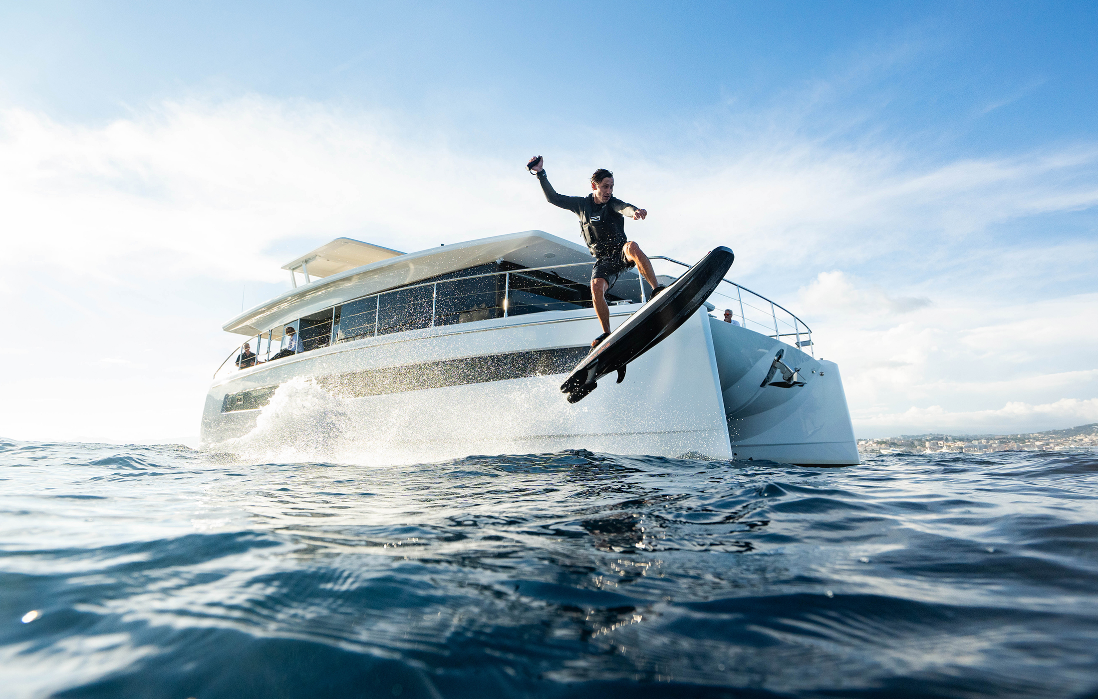 Man jumping with the Awake water toy in front of a Silent yacht