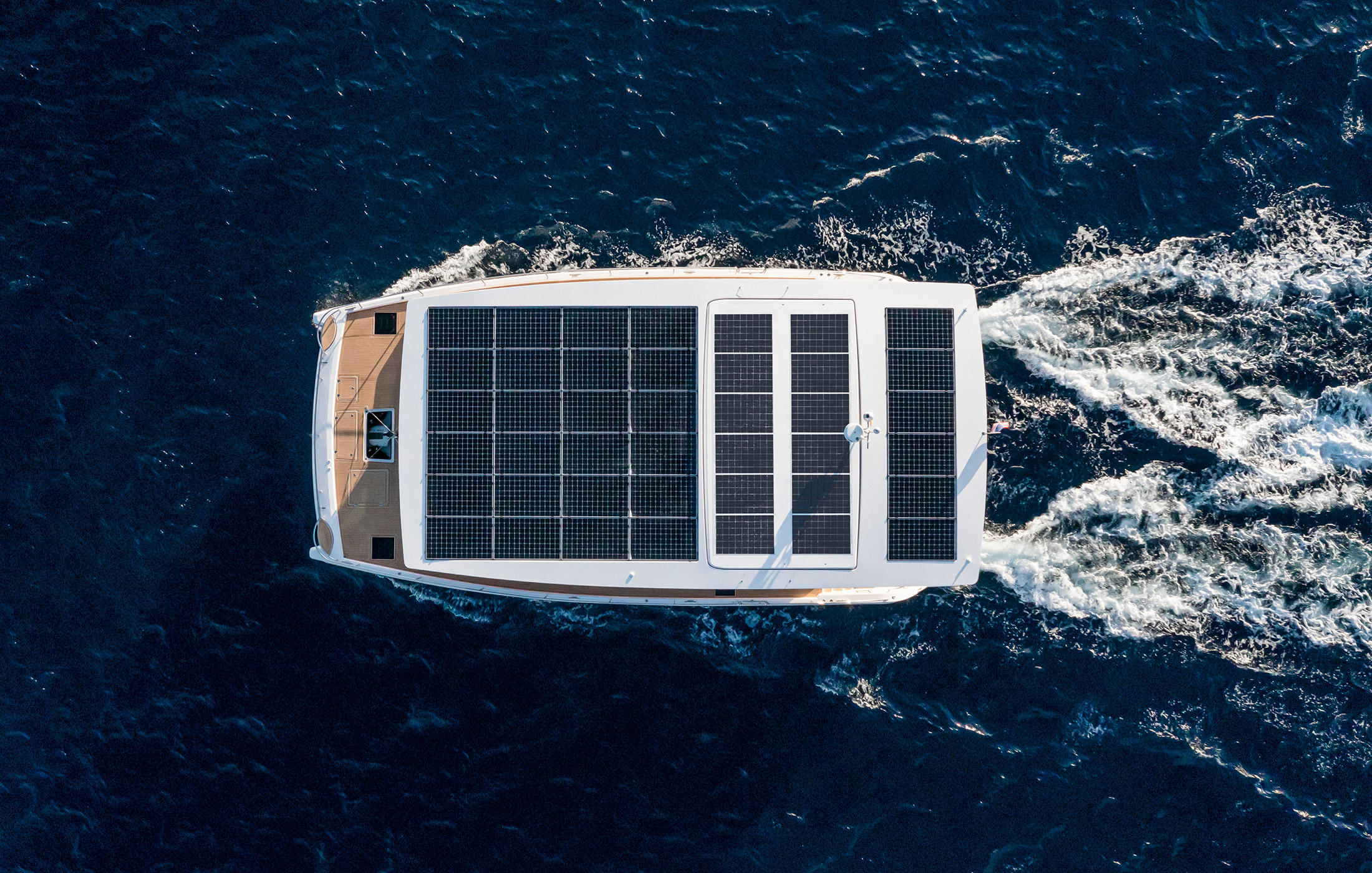 Silent yacht with solar panels on the roof sailing at high speed